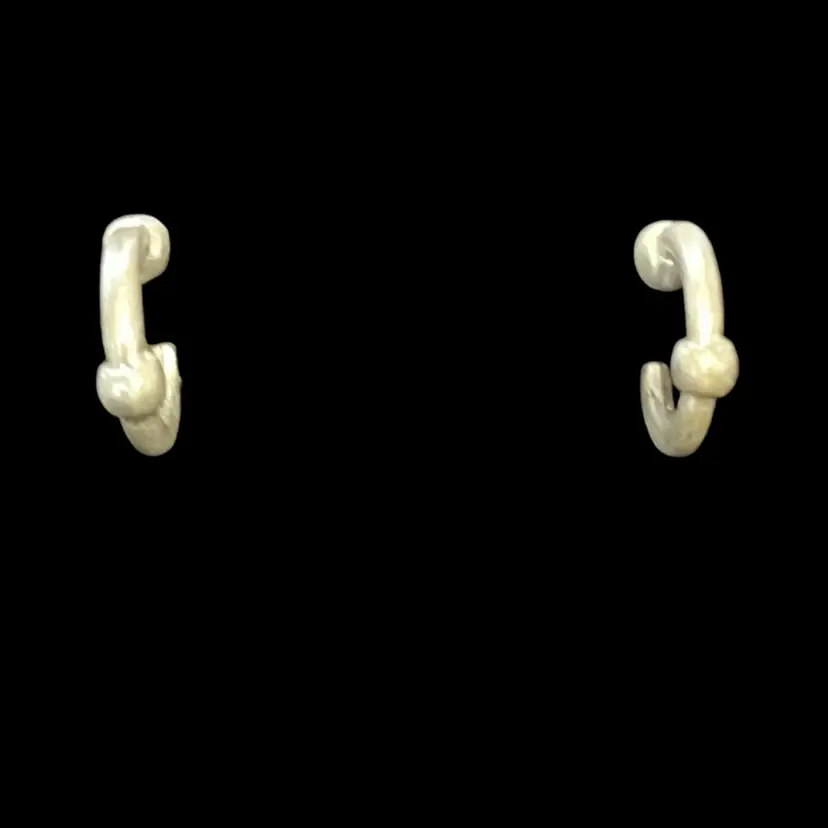 Silver toned hoop earrings with a little ball