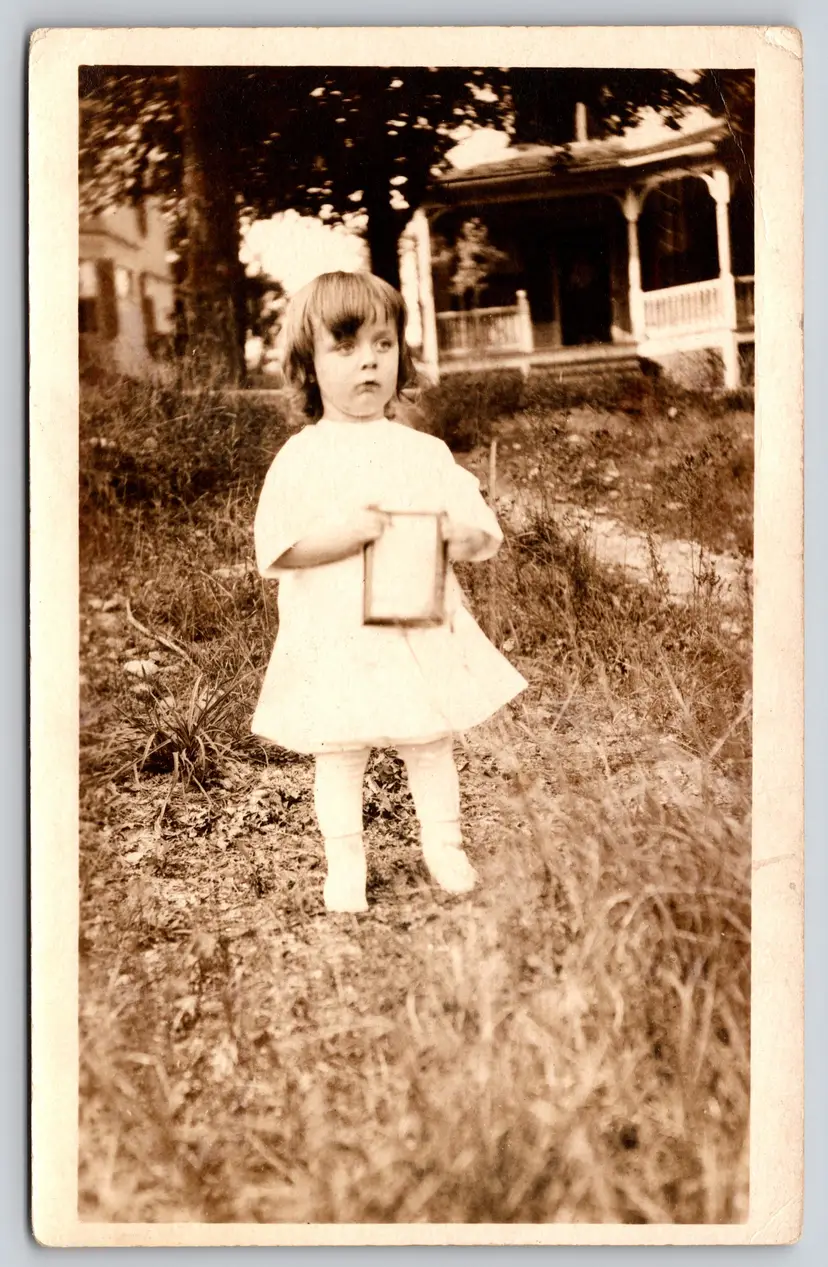 Postcard RPPC Concerned Girl Holding Book? Outside Real Photo White Hair Bow - 9119