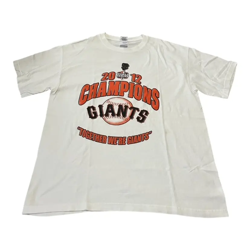 Celebrate the San Francisco Giants' incredible 2012 World Series victory with this officially licensed Majestic T-shirt. Featuring the iconic team logo and championship design, this large-sized shirt is perfect for fans and collectors alike. Made from high-quality materials, it’s a great way to show off your Giants pride!  Features:  Team: San Francisco Giants  Event: 2012 World Series Champions  Brand: Gildan Heavy Cotton  Size: Large  Material:  100% cotton Preshrunk  Color: White  Condition: Good condition