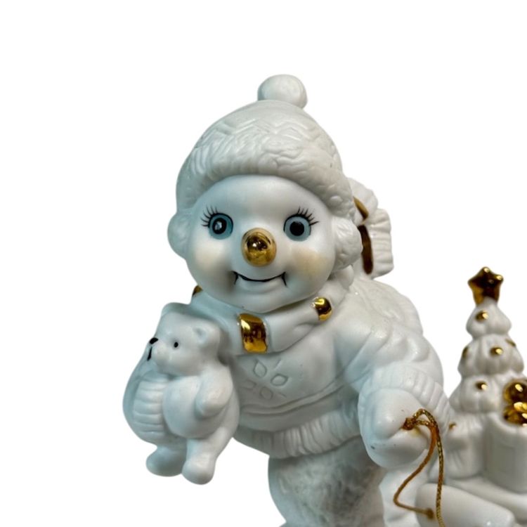 White Porcelain Snowman Figurine Grandeur 2000 Snowman Sled Teddy Bear Toys 
5” T x 6” L x 3” W