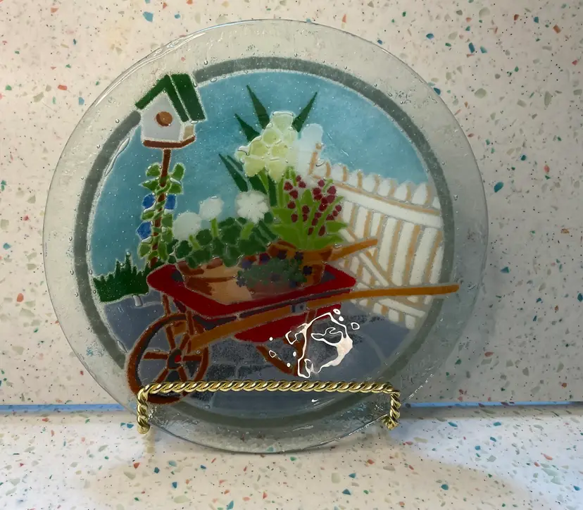 #01 Peggy Carr spring fused glass bowl with wheelbarrow, garden flowers, white picket fence, birdhouse