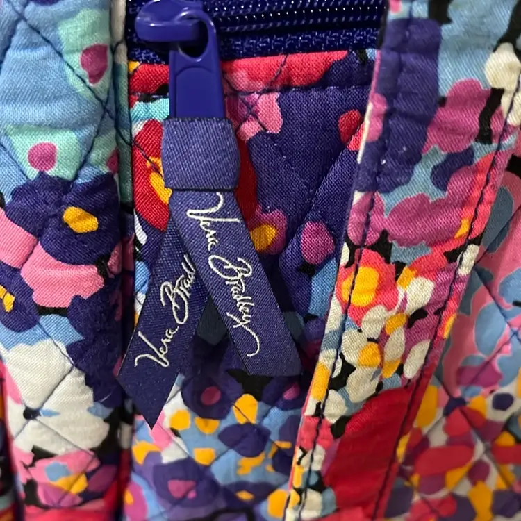 This is a Vera Bradley Stroll Around Baby Bag Or is a large tote bag with a colorful floral pattern. The bag features a laminated, easy-clean interior liner and multiple pockets for organization. Exterior features include two slip pockets, a zip pocket, and a front compartment containing a removable changing pad. It includes a 15" strap drop and removable 12" stroller straps to attach to a stroller handle. 17” Wide  By 11” Tall Excellent Condition