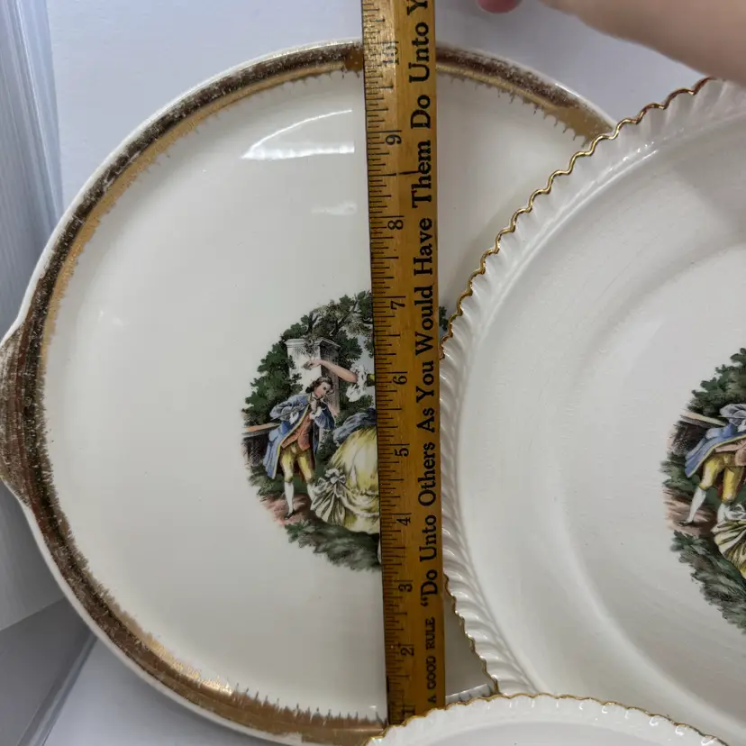 Vintage Harker Pottery plate with Godey Prints decoration and gold trim.