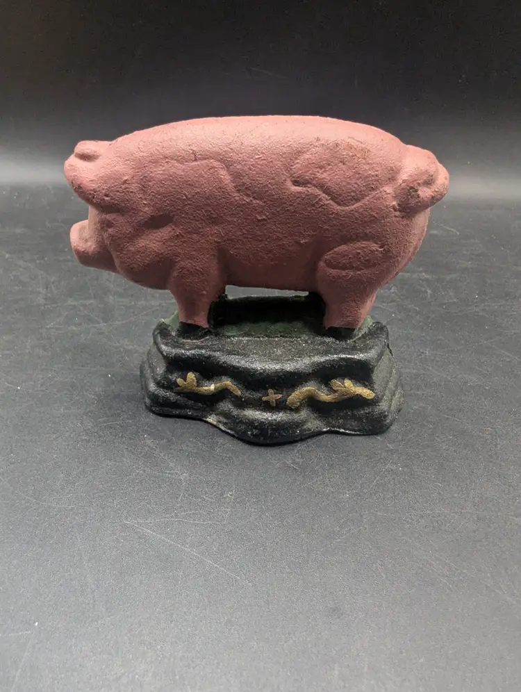 Vintage Cast Iron Pink Pig Door Stop on Green Base.