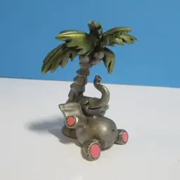 vintage 1982 Hudson pewter small elephant relaxing under palm tree figure