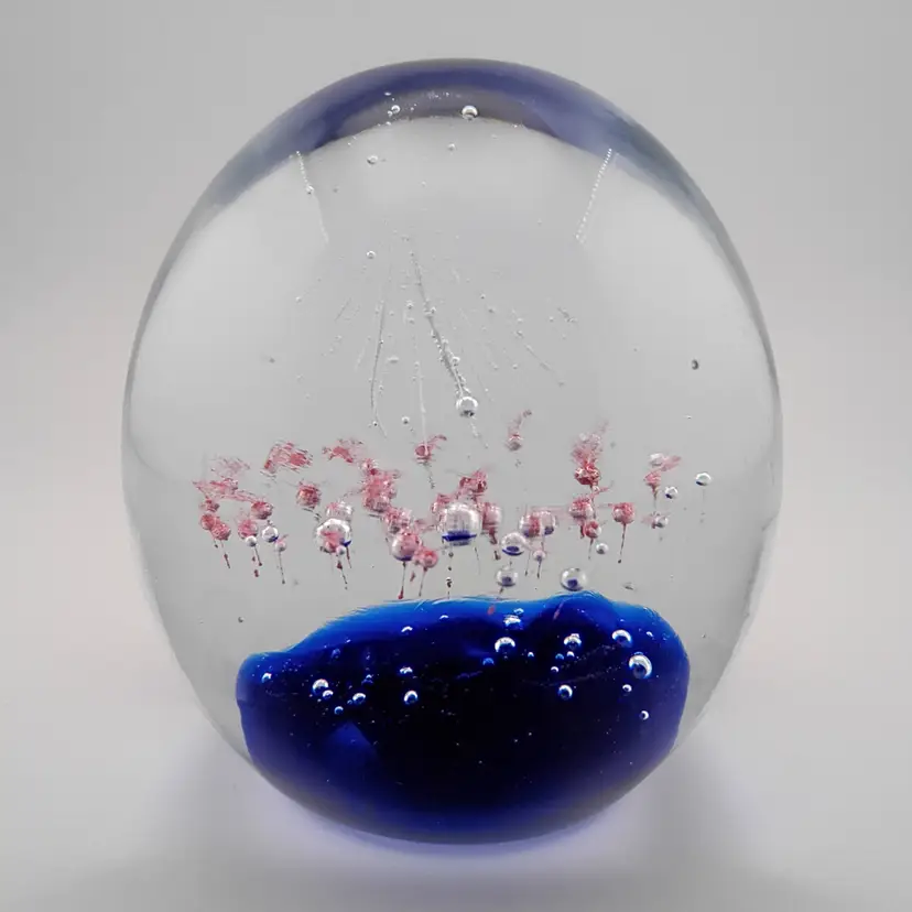 Paperweight with white firework and pink bubbles over cobalt ground