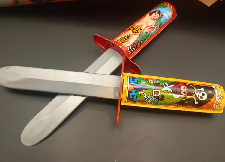 Vintage Retractable Tarzan and Pirate Tin Toy Knives..