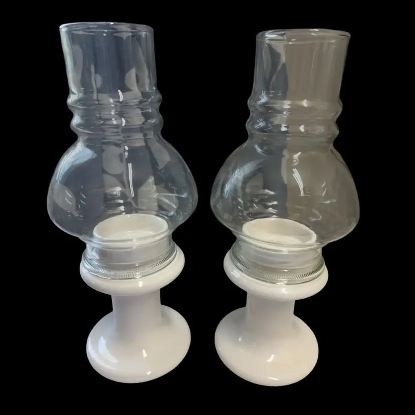 Pair of vintage hurricane candle holders with glass chimneys and ceramic bases.