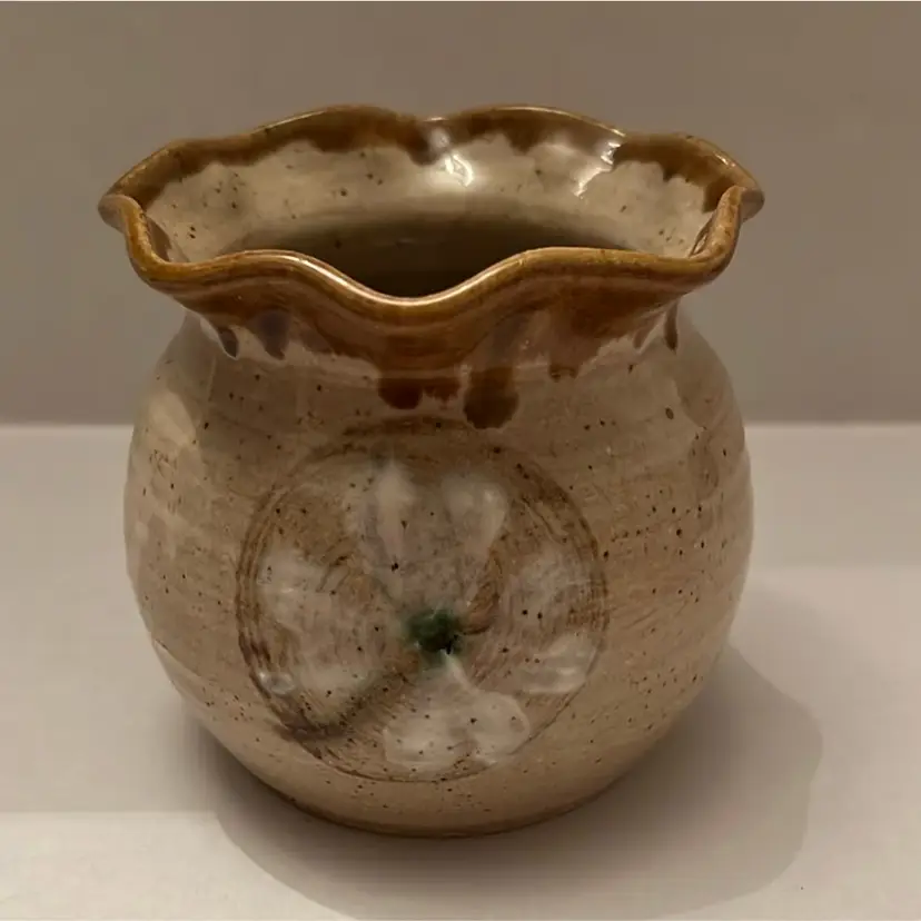 Tan pottery vase with flower hand painted. It is signed P.Vick 86