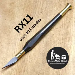 Ebony and brass "RX11" xacto-ish knife. Holds xacto no11 and similar blades. 
Brass hardware and handle made by me from scratch in my basement shop. Hexagonally faceted contoured handle (modeled after my favorite vintage xacto knife) feels great in the hand, lends detail control, and won't roll off your bench. The brass blade wrench snaps onto a rare earth magnet embedded in the handle with a satisfying click! 
Includes assortment of blades, storage tube, and some stickers and stuff. 
100% Satisfaction Guarantee – If the product does not meet your expectations, return it in lightly used condition for a full refund.
Lifetime Warranty – If the product should fail due to defect in material or workmanship before the I die or am incapacitated, return it for repair or replacement.
I have some others on hand in a variety of materials and configurations and I build to order - message me for more info.