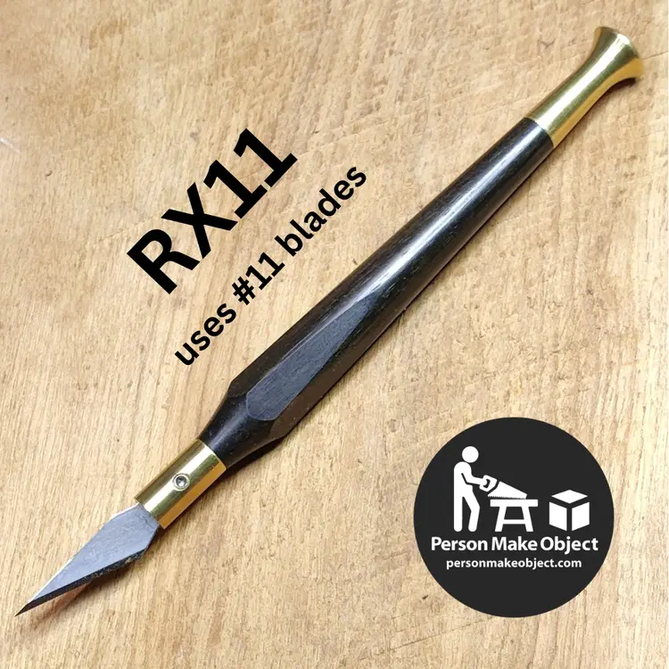 Ebony and brass "RX11" xacto-ish knife. Holds xacto no11 and similar blades. 
Brass hardware and handle made by me from scratch in my basement shop. Hexagonally faceted contoured handle (modeled after my favorite vintage xacto knife) feels great in the hand, lends detail control, and won't roll off your bench. The brass blade wrench snaps onto a rare earth magnet embedded in the handle with a satisfying click! 
Includes assortment of blades, storage tube, and some stickers and stuff. 
100% Satisfaction Guarantee – If the product does not meet your expectations, return it in lightly used condition for a full refund.
Lifetime Warranty – If the product should fail due to defect in material or workmanship before the I die or am incapacitated, return it for repair or replacement.
I have some others on hand in a variety of materials and configurations and I build to order - message me for more info.