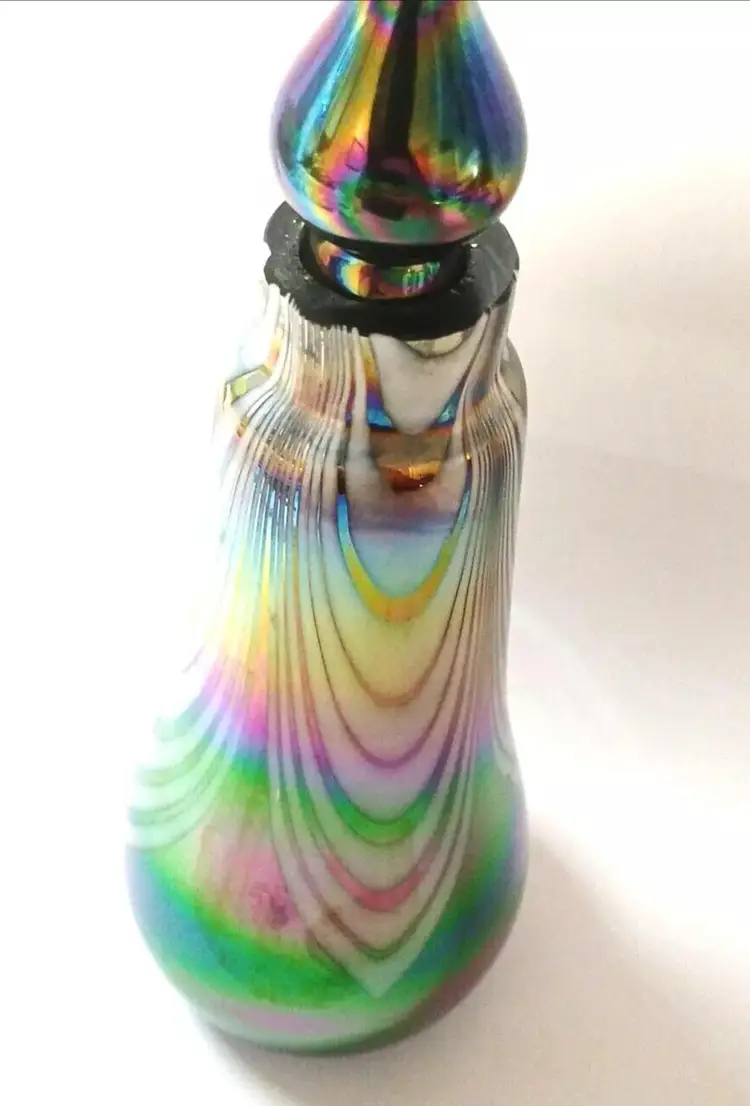 Vintage Iridescent Art Glass Perfume Bottle 6¾" Tall Multicolor.6¾" tall x aprox 2¼" wide.A few "flea bites" on top....please see last photo for close-up.Unbranded.Glass.