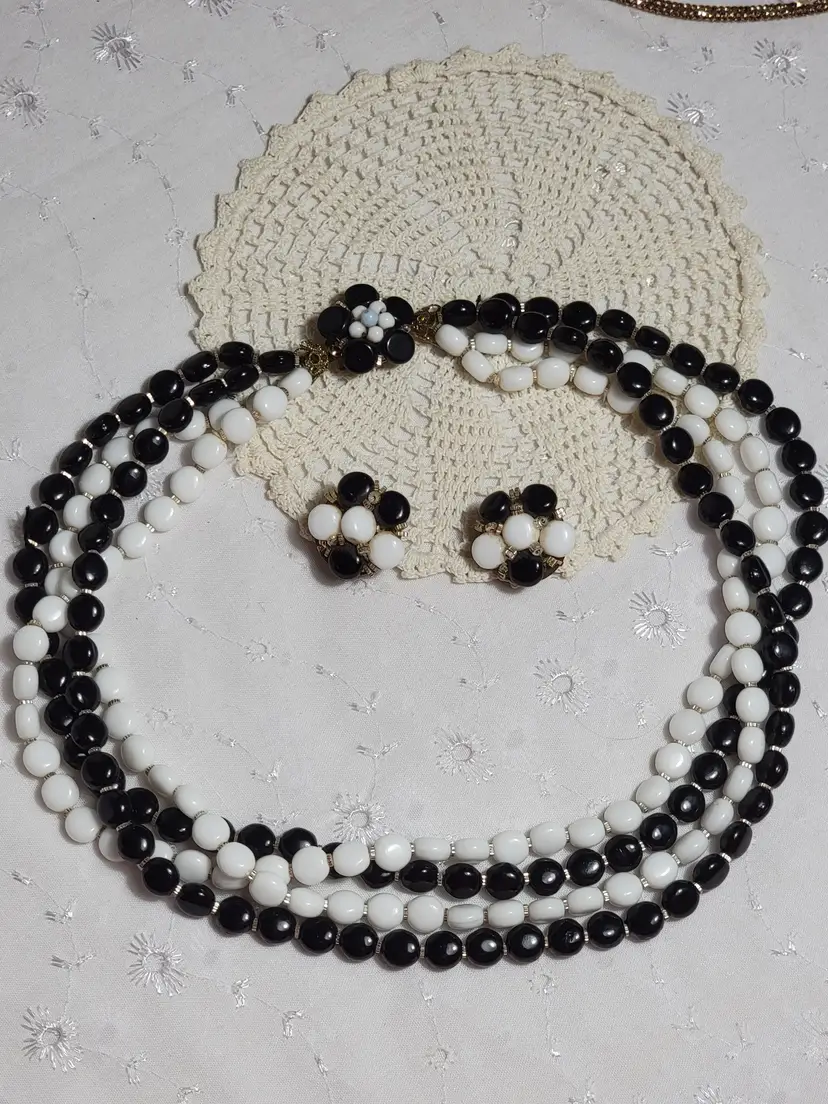 West Germany Demi-parure set. A 4 strand of black and white glass necklace and clip-on earrings