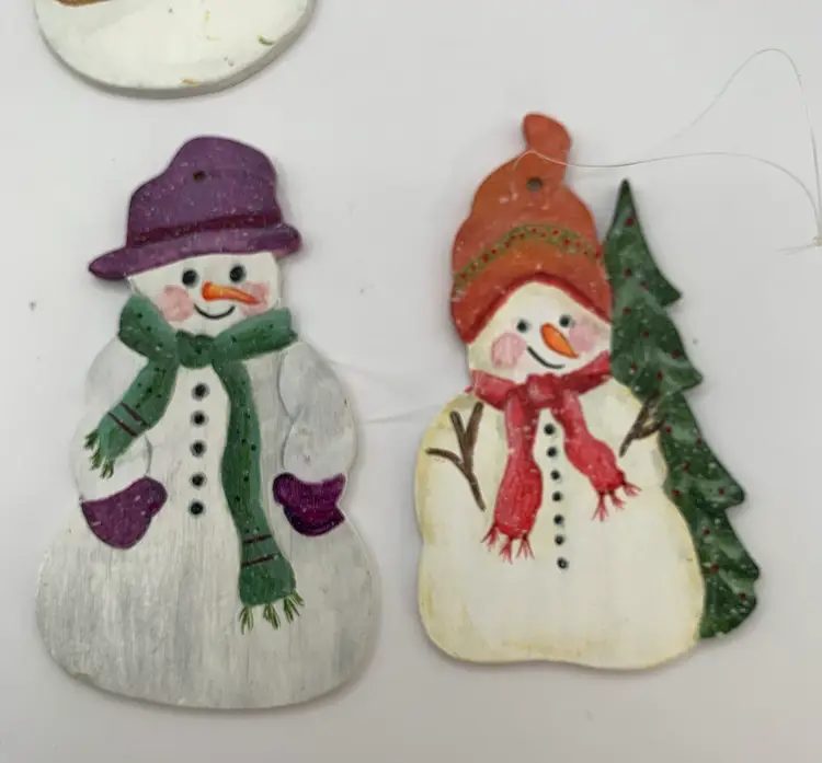 6 Cute hand painted wood snowman ornaments. Approximately 3 1/2 inches tall. Signed by the artist on the back.(Cowham? 1995)
