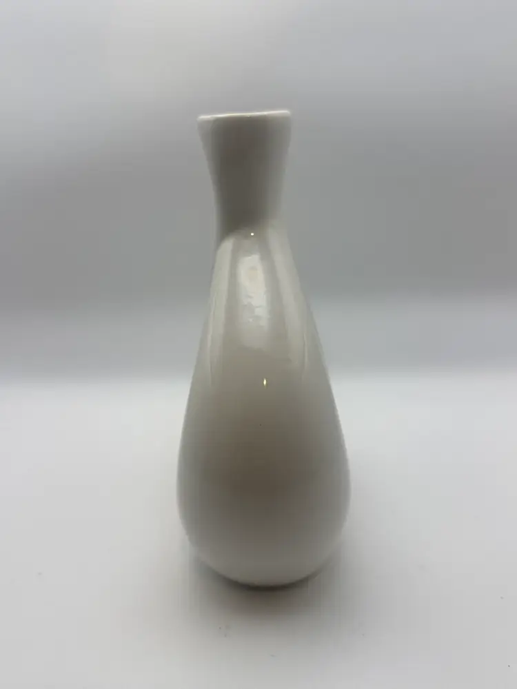 White ceramic R. Coleman vase with the inscription "FROM ONE COMES TWO COMES ONE COMES NEW." Signed By R. Coleman.