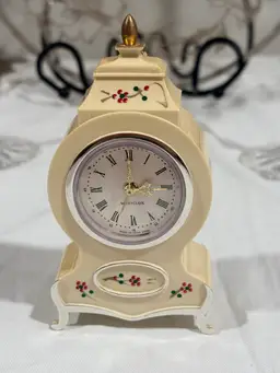 Vinntage Westclox miniature wind-up alarm clock with a hand-painted plastic