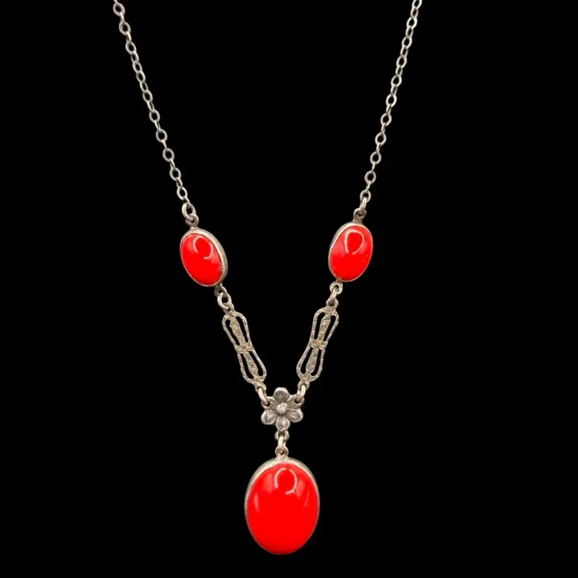 vintage Art Deco necklace featuring red glass cabochons and ornate silver-toned filigree.