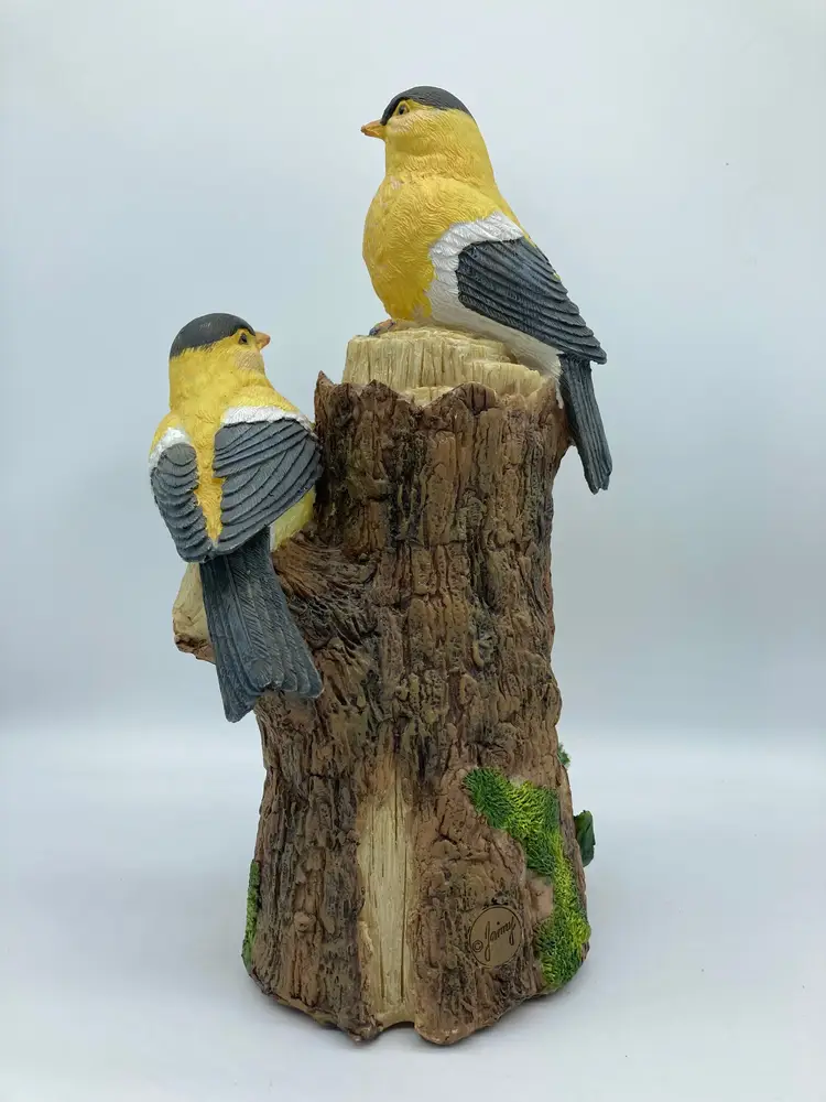 2 Yellow Goldfinches on a Tree Stump