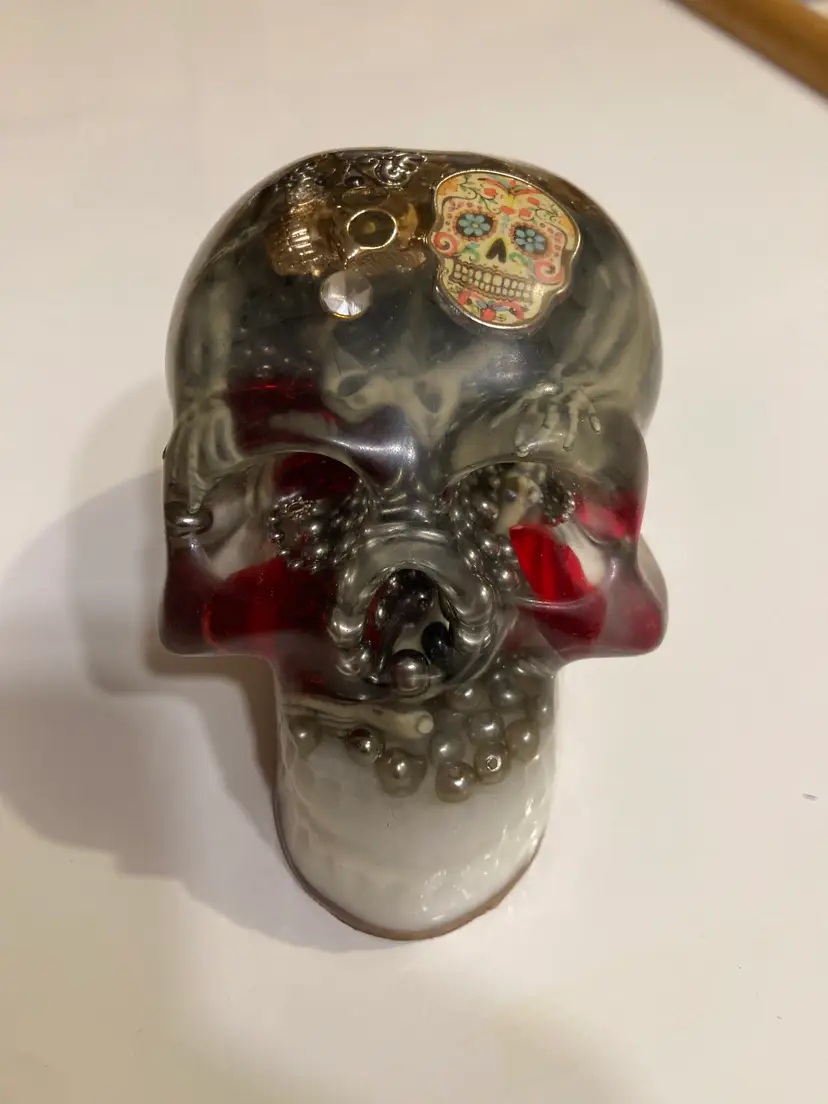 Resin skull filled with skeleton parts and red hearts figure paperweight