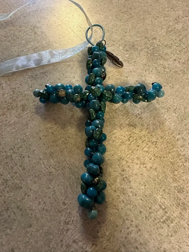 Handcrafted beaded cross ornament with blue glass beads and metal wire
