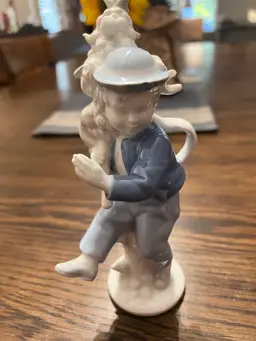 Little boy holding a tree