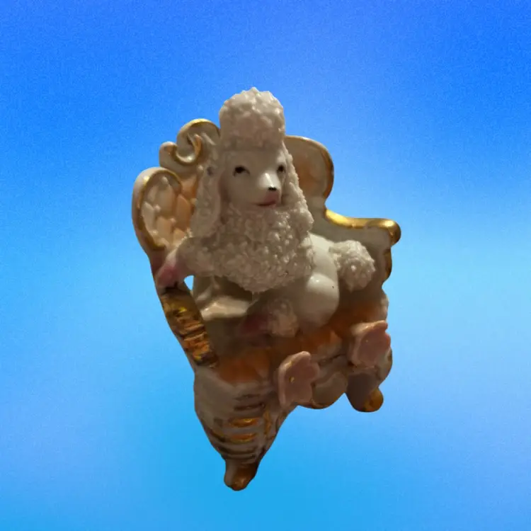 White Porcelain Spaghetti Poodle Figurine Sitting On An Elegant Gold Trimmed Chair
