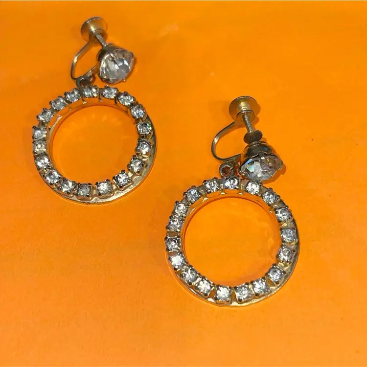 Vintage Signed Coro 60s Rhinestone Screw Back Hoop Earrings Set in Gold Metal.