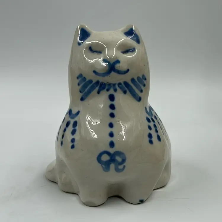 Vintage Folk Art MA Hadley Pottery Cat With Blue Bow And Markings. Looks Like A Glaze Skip On One Of The Feet See Photos.  4.5” T. 3.5” W. Signed On The Inside.