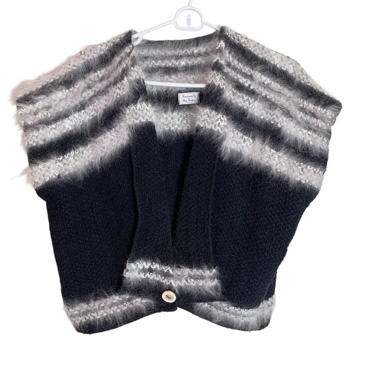 This is a handmade black and white striped mohair blend cardigan with a single button closure Cape