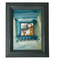 This Is a framed mixed media artwork by artist Amado Maurilio Peña Jr., dated 2009.  
The artwork depicts a figure, likely a Native American woman, in a fluid and stylized manner, a common subject for the artist. 
Peña is known for his work representing Native Americans and their connection to the Land. 
The piece incorporates a small central image mounted on a watercolor background with some small embellishments and a signature at the bottom.