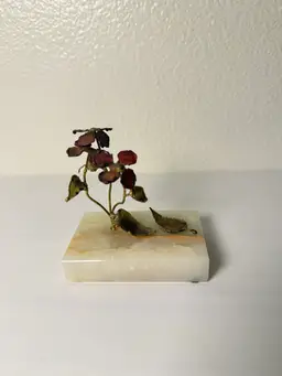 vintage Mid-Century Modern copper or brass flower sculpture on a stone base