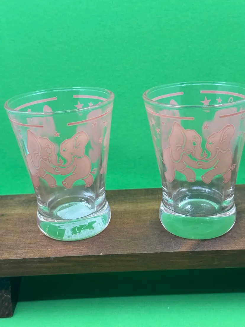 A set of two vintage Hazel-Atlas clear glass tumblers with pink elephant decals, 3.5”