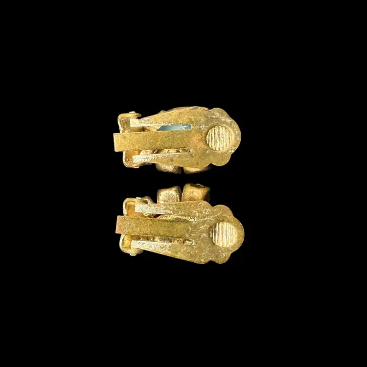 vintage clip-on earrings featuring a central turquoise-colored navette cabochon stones