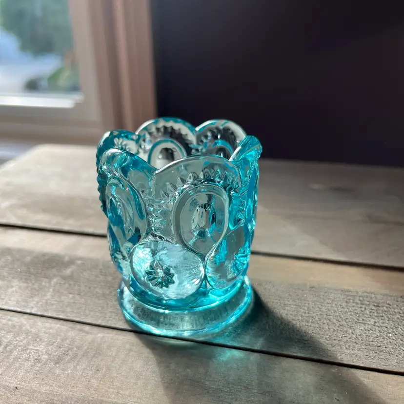 This is a blue pressed glass L.E. Smith Moon and Stars toothpick holder. 2.5”