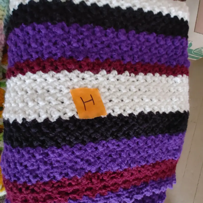 Afghan I- approx size 50 x 56. Purple, maroon, white & black stripes. As shown.