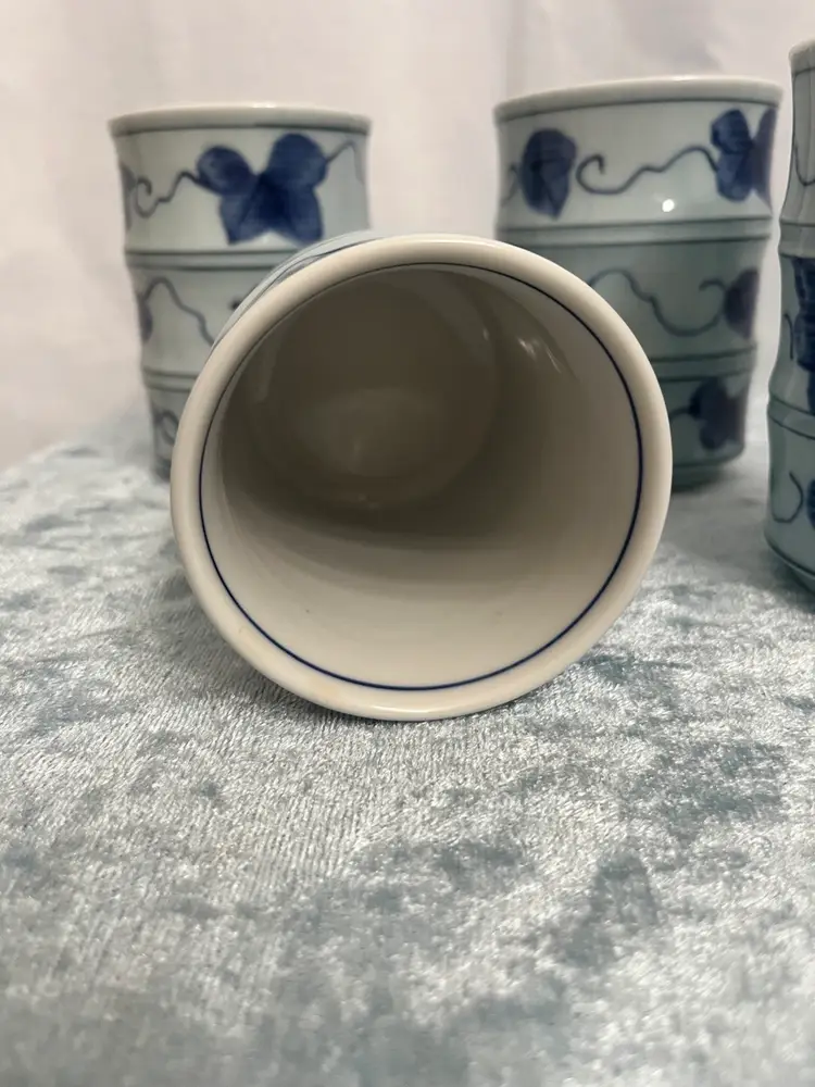 Set of 4 Japanese Yunomi tea cups, specifically identified as Arita ware (also known as Imari ware) due to their origin in the Arita region and their traditional blue and white design