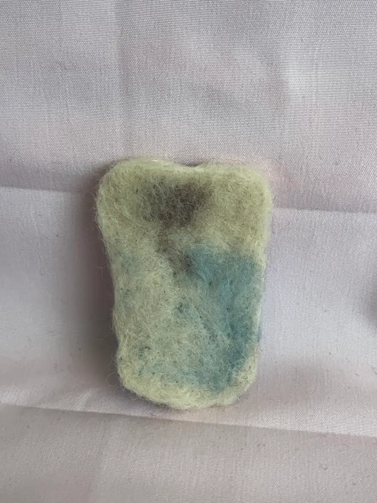 Needlefelted bear in bed