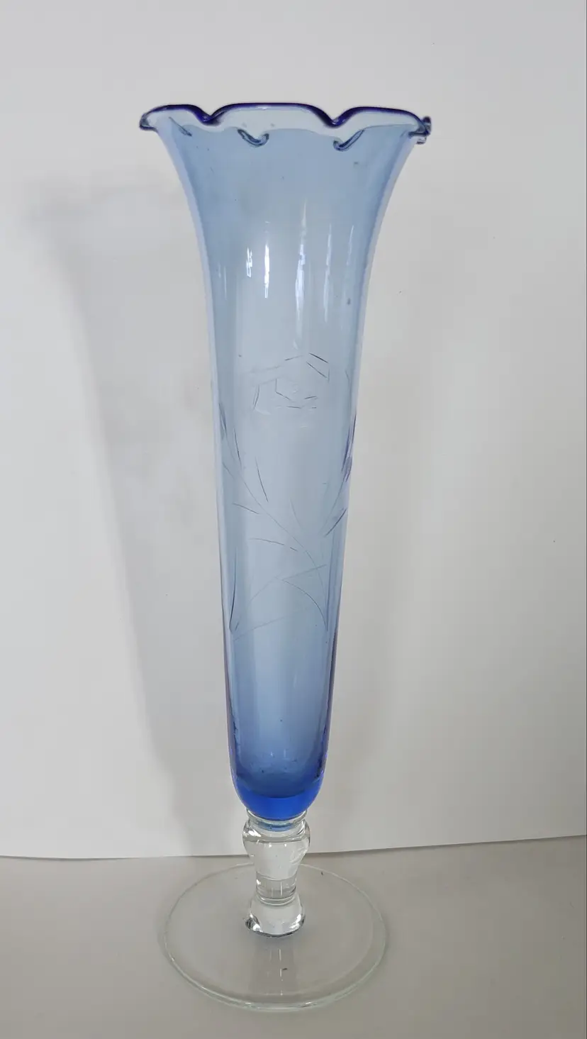 Blue fluted bud vase with 2 etched flowers. Scratches near top. 10.25 high.