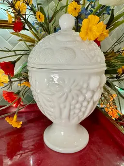 Vintage Avon milk glass lidded candy dish, embossed floral or fruit pattern. 6” tall & 4” wide