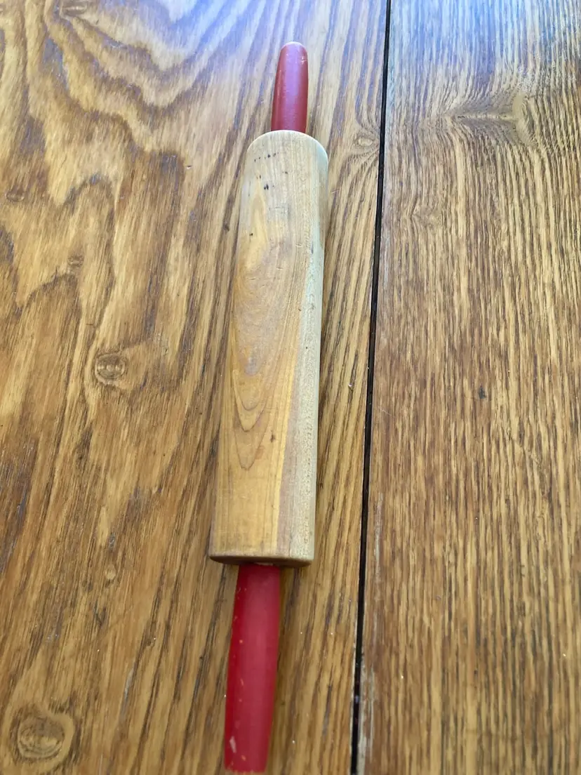 Vintage wooden rolling pin with red painted handles. 15.5”