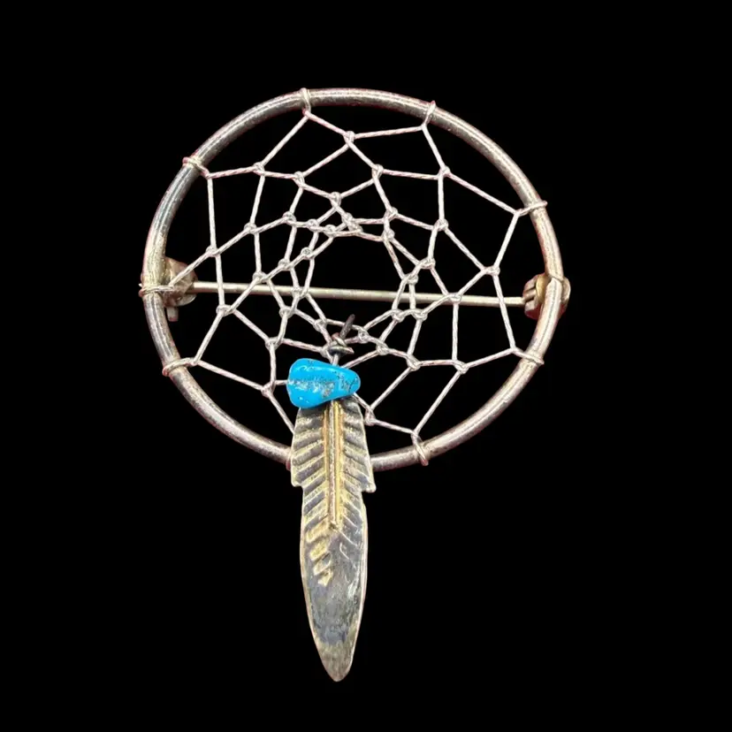 vintage Native sterling silver dreamcatcher brooch/pin with a dangling feather and turquoise accent.