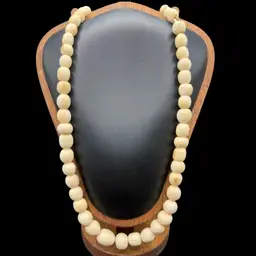 vintage carved bone or ox bone graduated bead necklace with a carved screw clasp