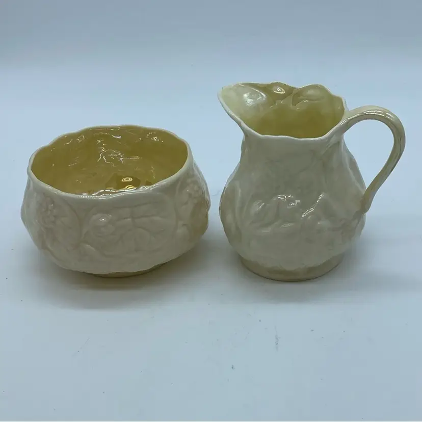 #1829 Belleek Lotus pattern cream and sugar set with embossed floral design.