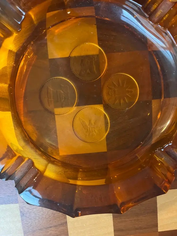 Amber Fostoria Coin Glass Ashtray with embedded coin designs. 8”
