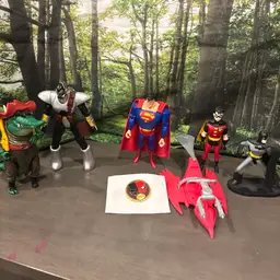 Dc Characters With Some Random Figures, Batman, Superman, And Robin