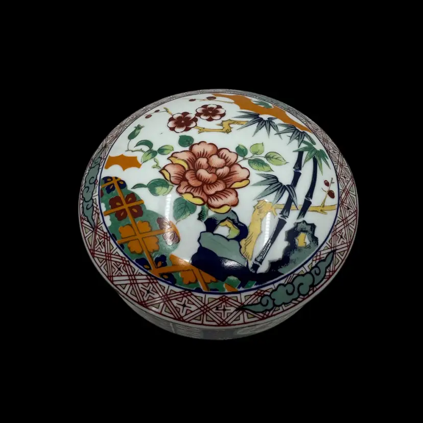 Imari-style porcelain lidded bowl with floral and bamboo motifs.