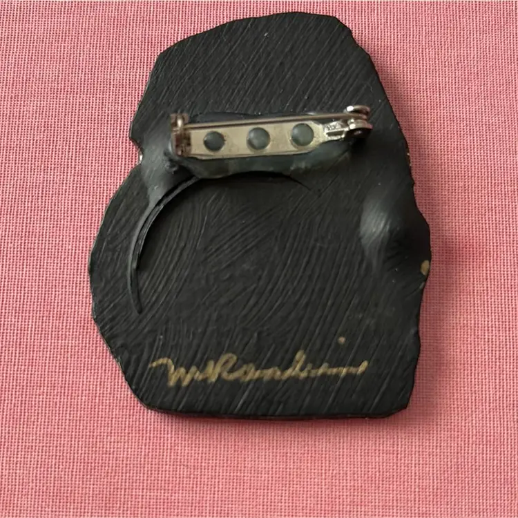 Handcrafted artisan brooch with "M. Rankin" signature.