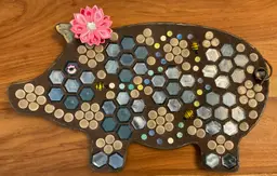 #01 Metal pig with mosaic tiles and lamp work bee beads. 17” long by 10” high. Grouted and sealed. The pink flower is just clipped on her ear.