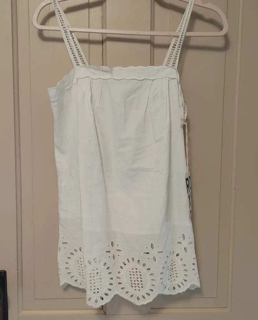Top- Brand: Roxy. Size Medium. White eyelet tank top. NWT. Sale priced $31.50. 100% Cotton. No callouts.