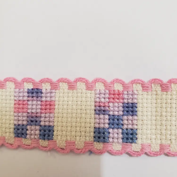 New Cross-stitched Ribband quilt themed ivory with pink trim.